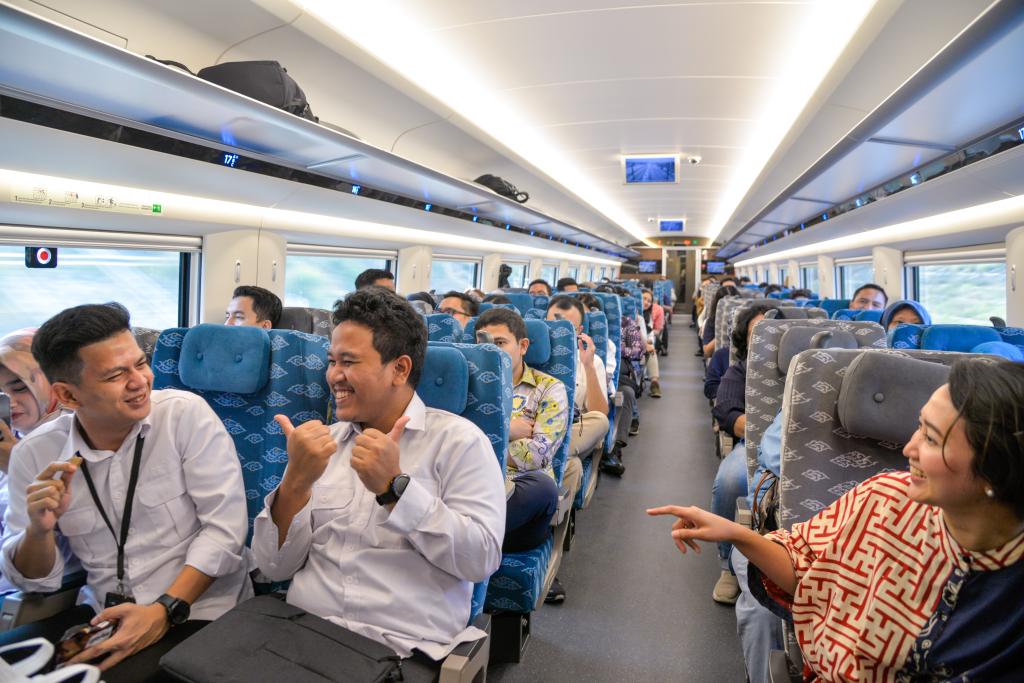 10月17日，乘客在行駛中的雅萬高鐵高速動(dòng)車組列車車廂內(nèi)交談。