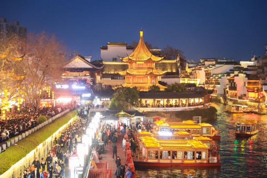 2月14日，游客在南京夫子廟景區(qū)賞燈游玩。（新華社發(fā)，蘇陽攝）