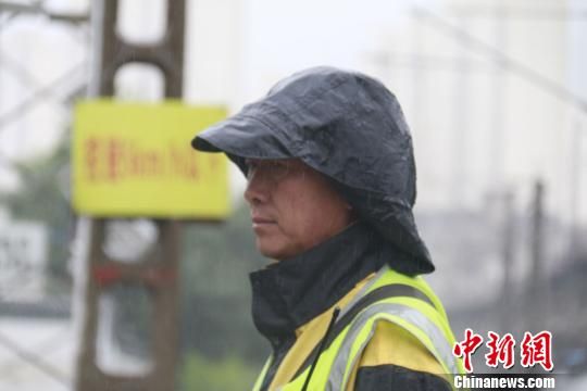 蘭州西工務(wù)段蘭州線路車間防護(hù)員雨中巡查?！⊥豕廨x 攝