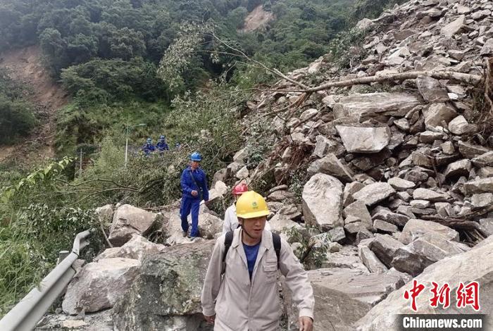 電力搶險(xiǎn)人員徒步通過垮塌路段。　四川電力供圖
