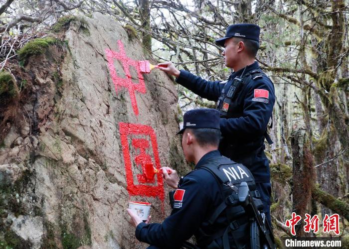 山南邊境管理支隊玉麥邊境派出所民警邊境巡邏途中在石頭上用油漆涂寫“中國”二字 。　鄭琦山 攝