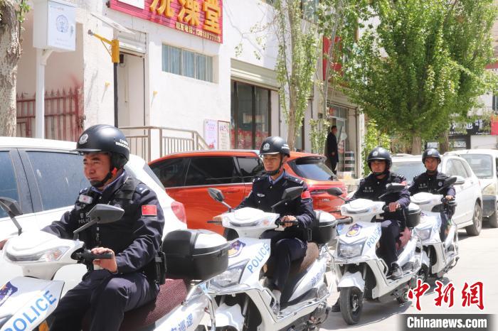 民警騎著電瓶車在轄區(qū)巡邏走訪?！↑S創(chuàng)偉 攝